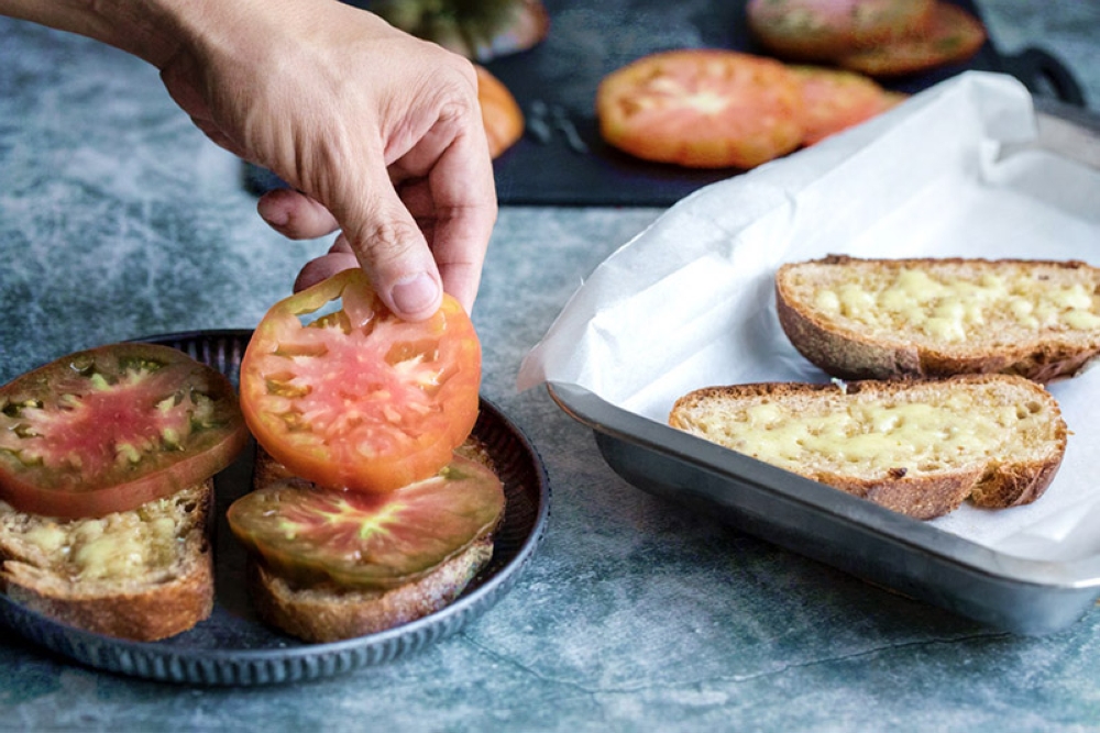To finish, place two slices of beefsteak tomatoes on each piece of toast.