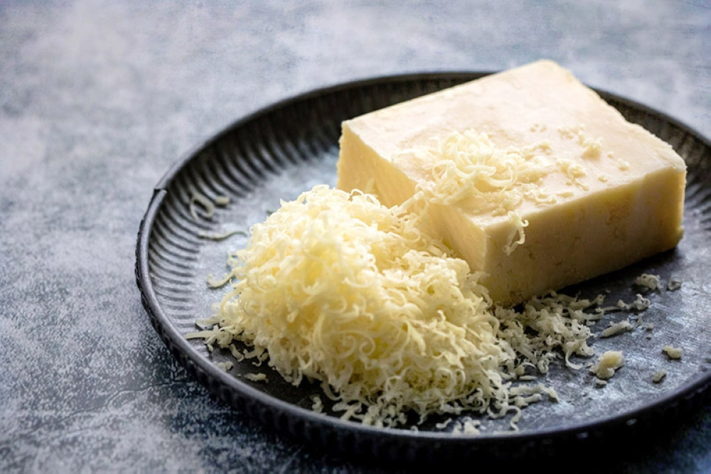 Freshly grated Cheddar cheese.