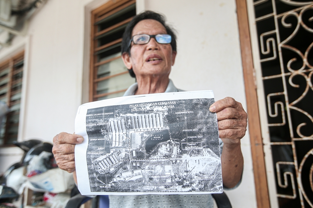 Wong Ha Ha, 72, one of the five co-land owners of the former Bukit Desa Rimba National Service camp in Sauk, Kuala Kangsar, shows the plan of the former camp site at his house in Sauk May 2, 2024. — Picture by Farhan Najib