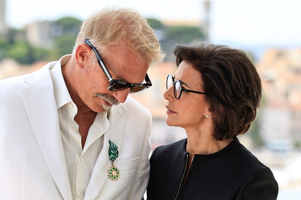 US director Kevin Costner (left) chats with French Culture Minister Rachida Dati after being awarded Chevalier de l'Ordre des Arts et des Lettres, on the sidelines of the 77th edition of the Cannes Film Festival in Cannes, southern France, on May 19, 2024. — AFP pic