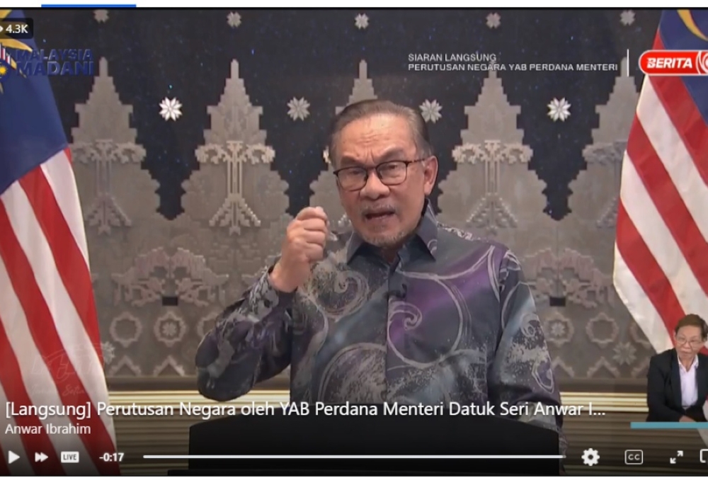 In a live address to the nation broadcast by all local media channels tonight, the prime minister said there have been attempts to disrupt peace in the nation and its thriving economy. — Screengrab from Facebook/Anwar Ibrahim  