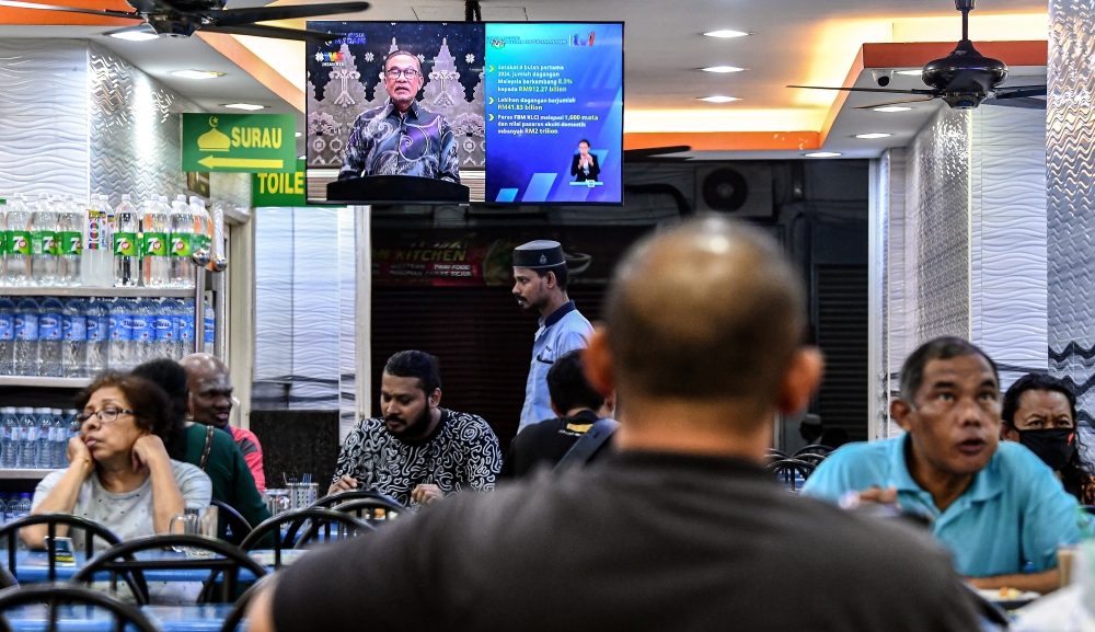 The public watch Prime Minister Datuk Seri Anwar Ibrahim’s national address broadcast live on television, at a restaurant in Kuala Lumpur, May 21, 2024. — Bernama pic 