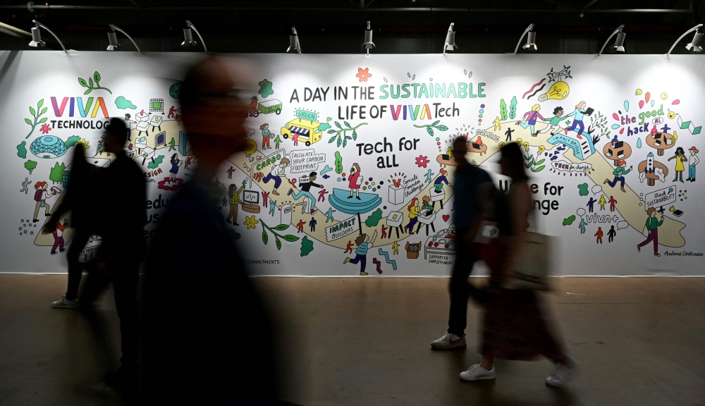 Visitors walk past a banner at the 8th edition of the Vivatech technology startups and innovation fair, at the Porte de Versailles exhibition centre in Paris May 23, 2024. — AFP pic