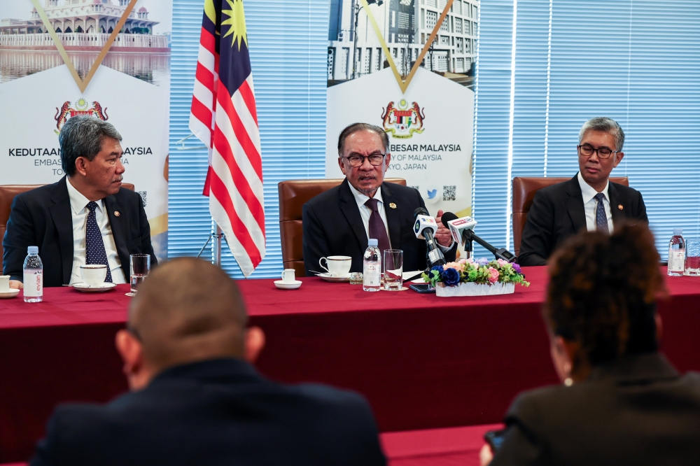 Prime Minister Datuk Seri Anwar Ibrahim speaks during a press conference at the end of his working visit to Tokyo. Also present is Foreign Minister Datuk Seri Mohamad Hasan, and Minister of Investment, Trade and Industry Datuk Seri Tengku Zafrul Abdul Aziz, Tokyo, May 24, 2024. — Bernama pic 