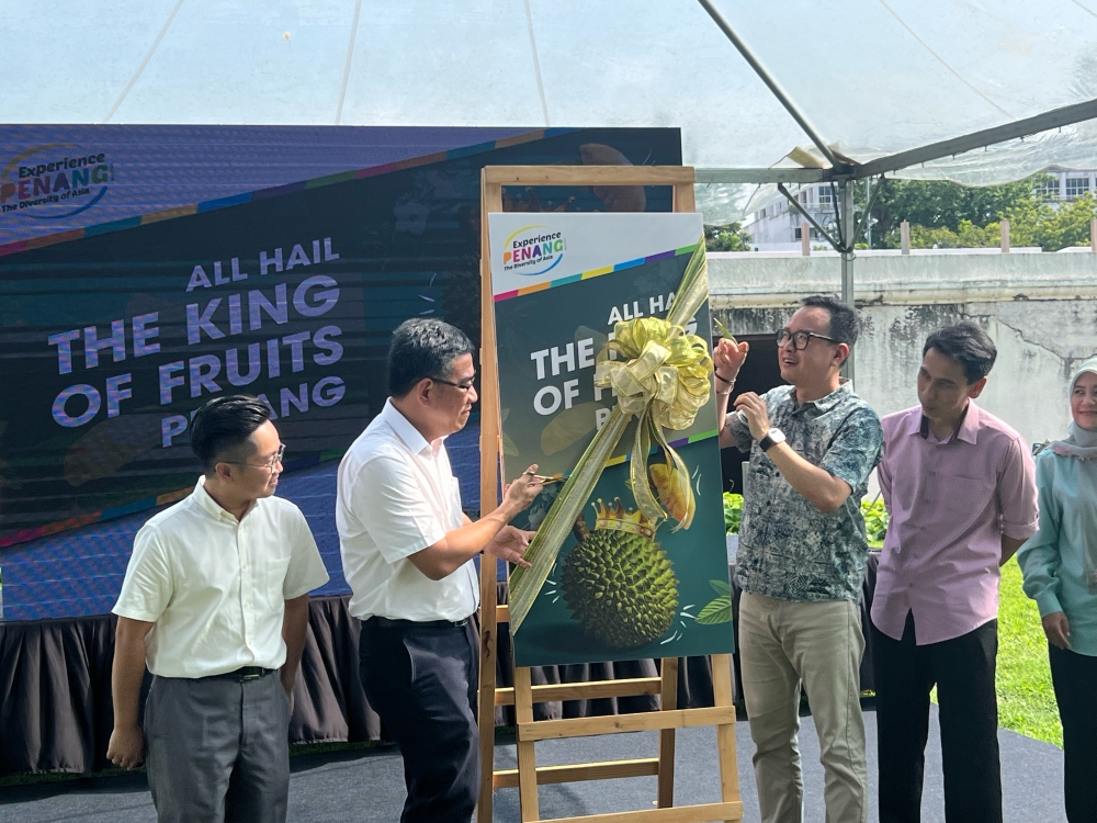 State tourism and creative economy committee chairman Wong Hon Wai (second from left)  launching the start of Penang's durian season.  — Picture by Opalyn Mok