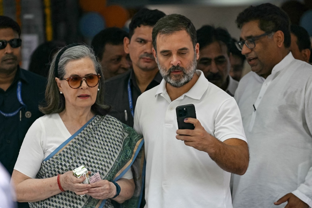 Indian National Congress (INC) party leaders Rahul Gandhi (third from right) with mother Sonia Gandhi (second from left) leaves a polling station after casting their ballot to vote during the sixth phase of voting in India’s general election May 25, 2024. — AFP pic