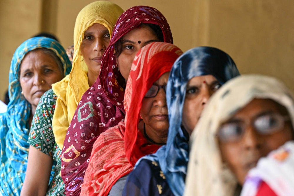 Women queue up to cast their ballots at a polling station during the sixth phase of voting in India’s general election, in village Tigaon on the outskirts of Faridabad May 25, 2024. — AFP pic