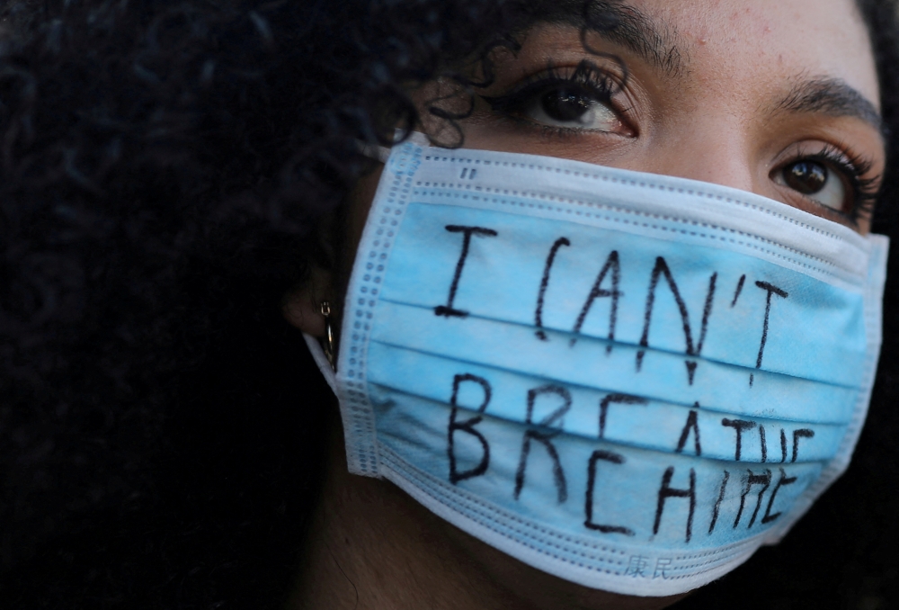 File photo of a woman wearing a face mask with the words ‘I can’t breathe’ lookin on during a protest against the death in Minneapolis police custody of George Floyd, in front of a US consulate in Barcelona, Spain, June 1, 2020. — Reuters pic