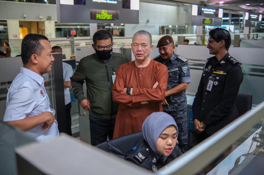 Deputy Prime Minister Datuk Seri Fadillah Yusof (in brown shirt) inspecting the immigration counters at the Customs, Immigration and Quarantine complex in Johor Baru May 27, 2024. — Picture courtesy of the Home Ministry 