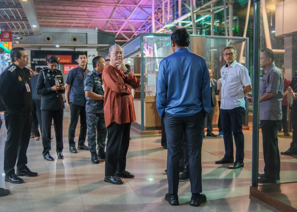 Deputy Prime Minister Datuk Seri Fadillah Yusof (in brown shirt) pays a surprise visit to the Customs, Immigration and Quarantine complex in Johor Baru May 27, 2024. — Picture courtesy of the Home Ministry 