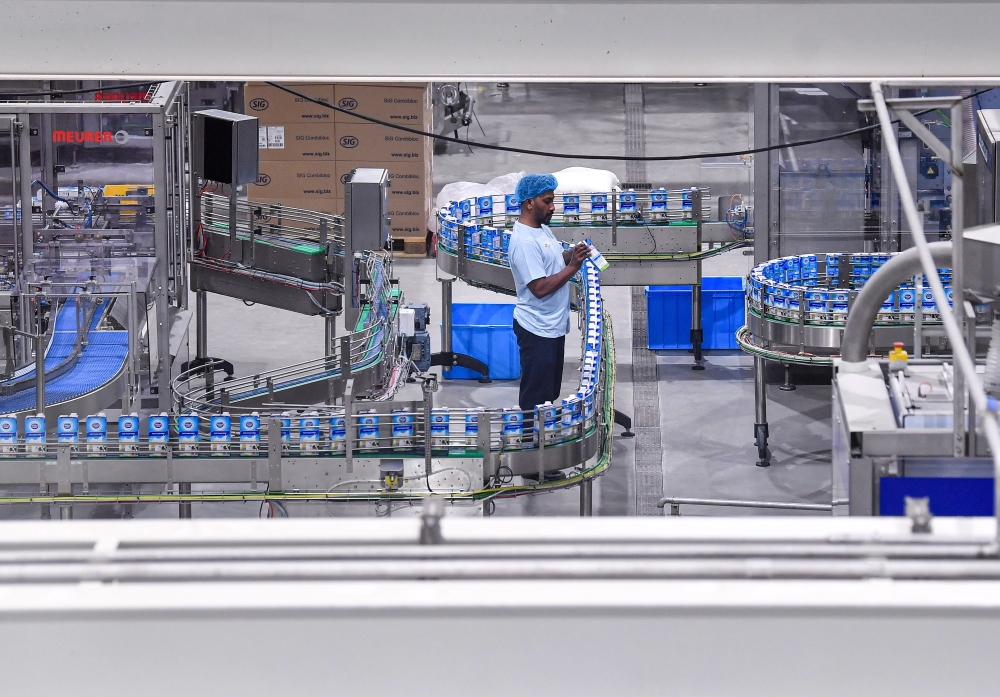 A worker is seen doing his daily work during the factory tour as part of the inauguration of Dutch Lady Milk Industries Berhad's manufacturing facility by the Negeri Sembilan Yang Dipertuan Besar  Tuanku Muhriz Tuanku Munawir in Bandar Enstek May 30, 2024. — Bernama pic