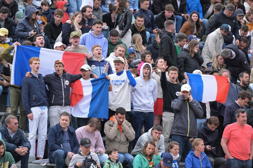 French fans with French national flags chant during France’s Giovanni Mpetshi Perricard and Belgium’s David Goffin’s men’s singles match on day three of the French Open tennis tournament at the Roland Garros Complex in Paris on May 28, 2024. — AFP pic 