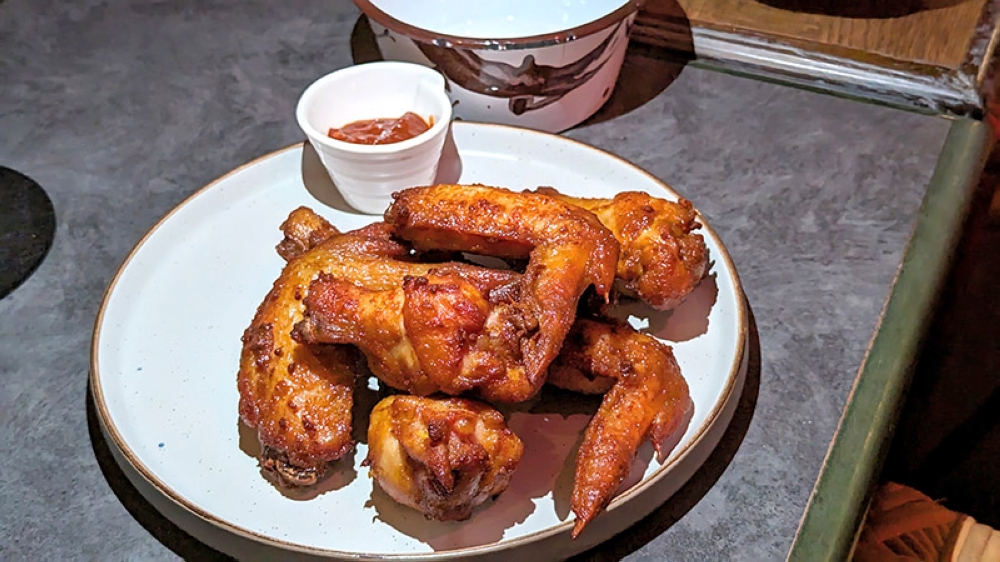 JungleBird’s KFC wings feature 'kunyit fried chicken' and a punchy hot sauce.