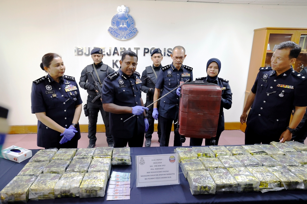 Selangor Police Chief Datuk Hussein Omar Khan with the seized drugs and the suitcase used to transport them at a media briefing in Sepang, May 31, 2024. — Bernama pic 