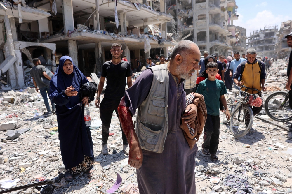 File photo of a Palestinian man who returned briefly to the Jabalia refugee camp in the northern Gaza Strip to check on his home, walking amid the rubble after he was injured in an Israeli strike on May 30, 2024, amid the ongoing conflict between Israel and the militant group Hamas. — AFP pic