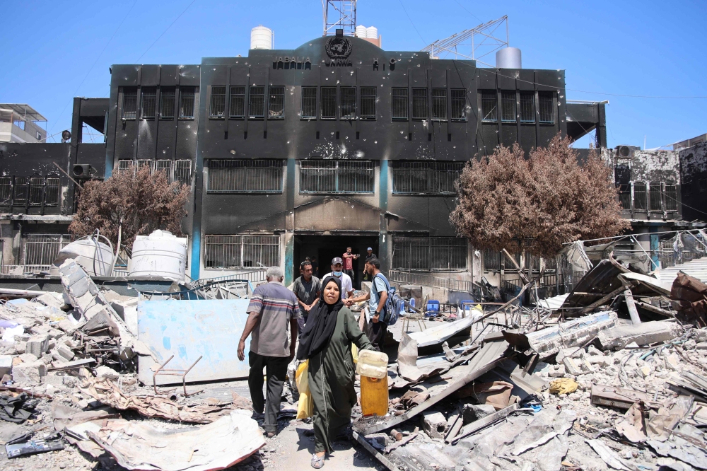 Palestinians salvage belongings from a damaged UN-run school in the Jabalia refugee camp in the northern Gaza Strip after they returned briefly to check on their homes on May 31, 2024, amid the ongoing conflict between Israel and the militant group Hamas. — AFP pic