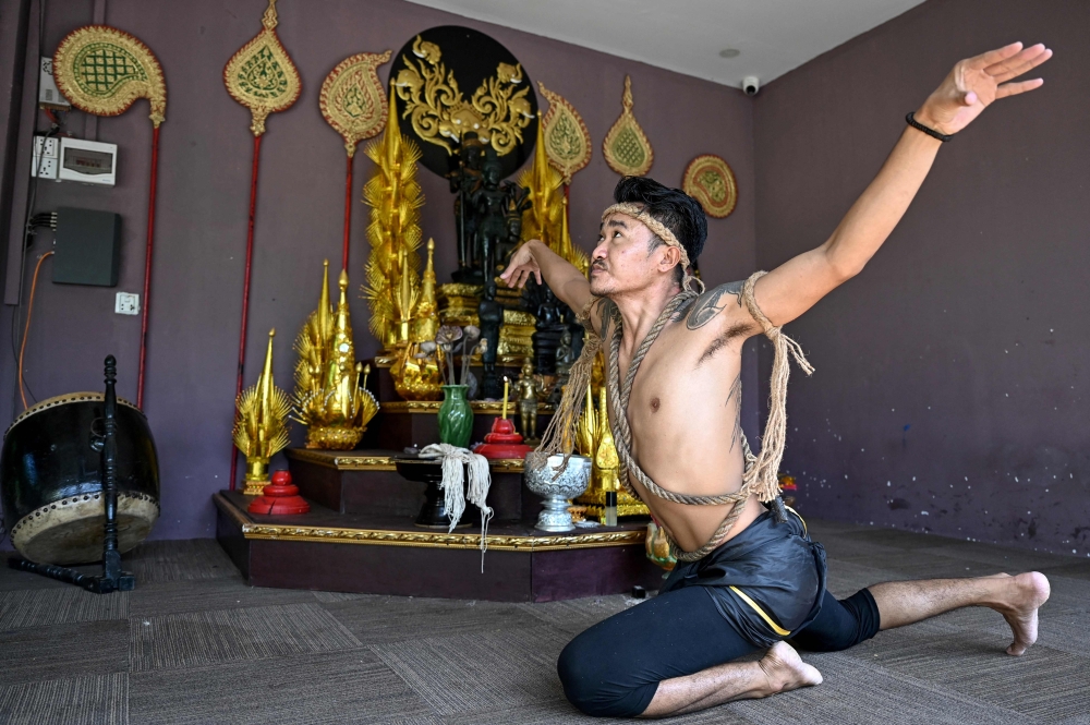 Ancient Khmer martial art Yutkromkhorm practitioner Kim Bonneat performing at his club in Krong Areyksat. — AFP pic