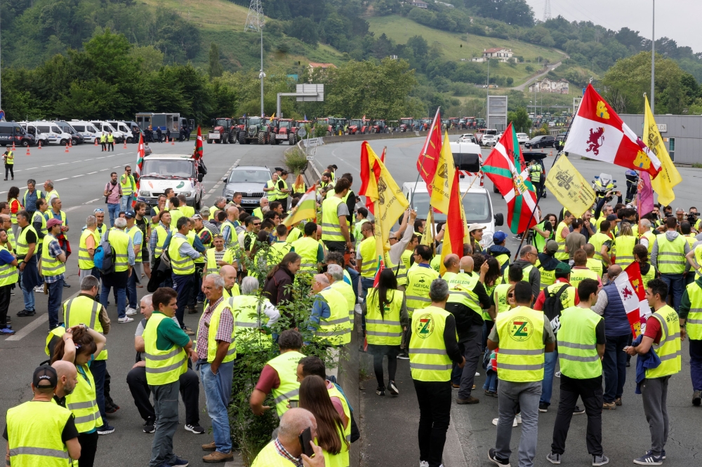 Farmers use their tractors to block the border between Spain and France, during a demonstration demanding better conditions ahead of European elections, Irun, Spain, June 3, 2024. — Reuters pic  