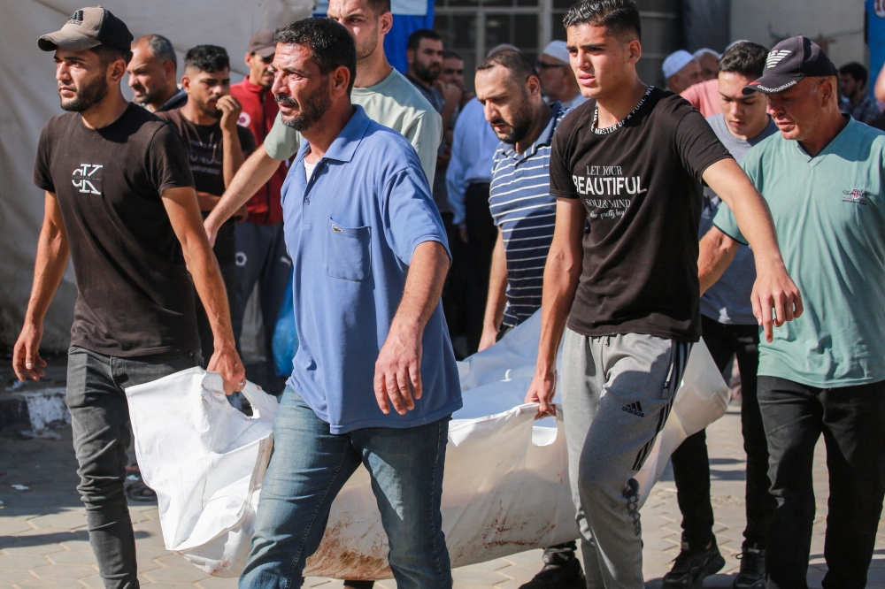 Palestinian mourners carry the body of a victim of Israeli bombardment, outside a hospital in Deir el-Balah in the central Gaza Strip on June 7, 2024, amid the ongoing conflict between Israel and the Palestinian Hamas militant group. ― AFP pic