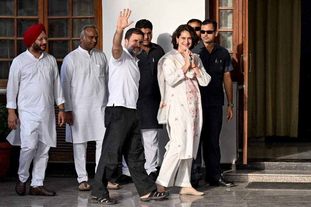 File photo of leaders of Indian National Congress party Rahul Gandhi (third left) and his sister Priyanka Gandhi Vadra (third right) gesturing to supporters as they arrive for a meeting in New Delhi on June 5, 2024, on the following day of voting results for India's general election. ― AFP pic