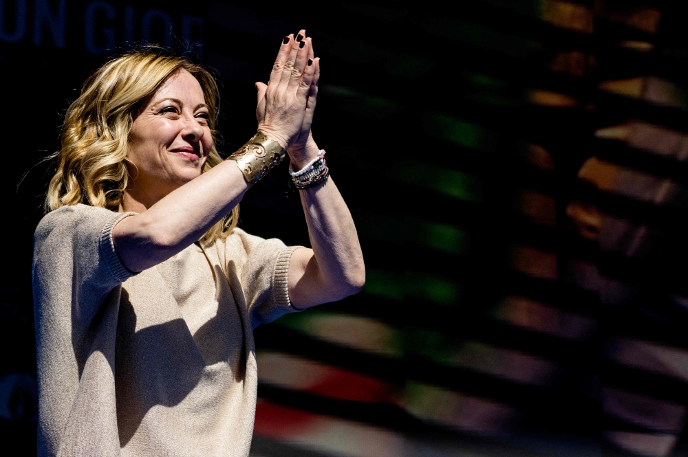 File photo of Italian Prime Minister Giorgia Meloni greeting supporters from the stage at the end of a campaign meeting of Italian far-right party ‘Fratelli d’Italia’ (Brothers of Italy) for the upcoming European elections, on June 1, 2024 in Rome. ― AFP pic