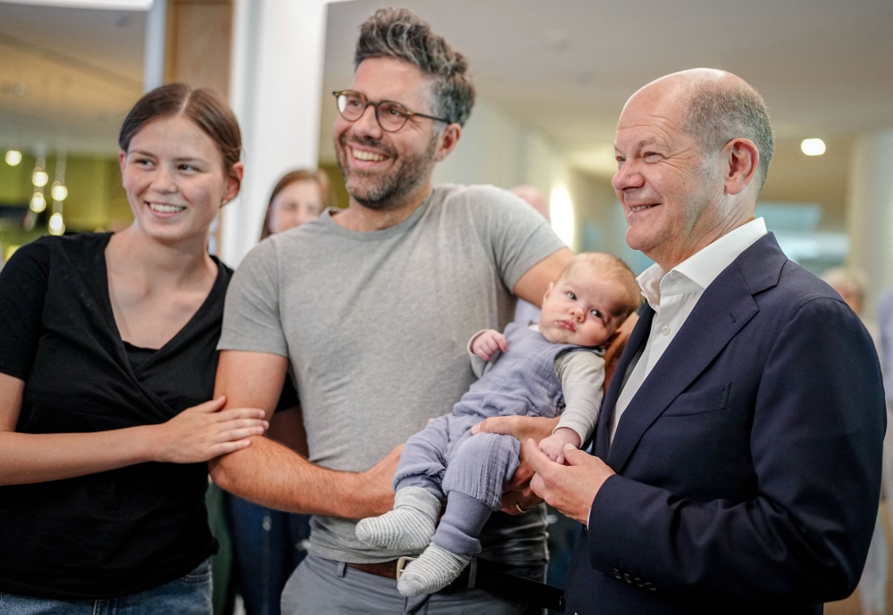 German Chancellor Olaf Scholz poses for a photo with Elisabeth and Valentin Jahn and baby Benedikt after voting during the European Parliament elections in Potsdam June 9, 2024. — Kay Nietfeld/Pool/Reuters pic  