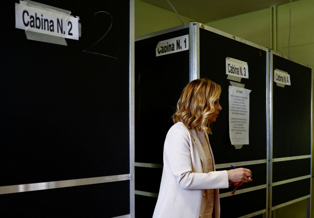 Italy's Prime Minister Giorgia Meloni leaves the voting booth after voting for the European Parliament elections, in Rome June 8, 2024. — Reuters pic  