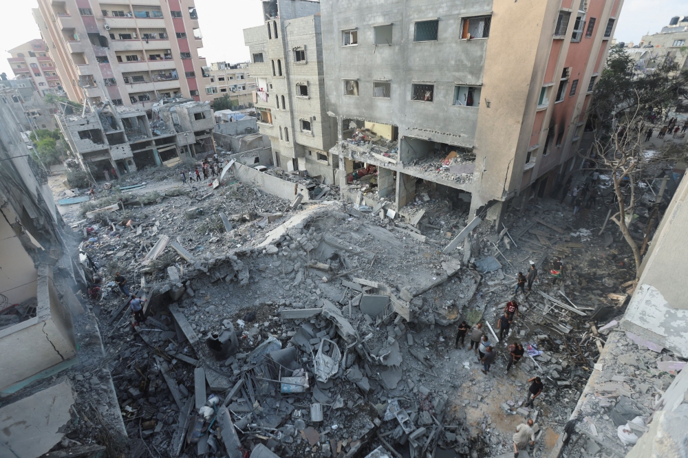 Palestinians inspect a house hit in an Israeli strike, due to an Israeli military operation, amid the Israel-Hamas conflict, in Nuseirat refugee camp in the central Gaza Strip, June 8, 2024. — Reuters pic  