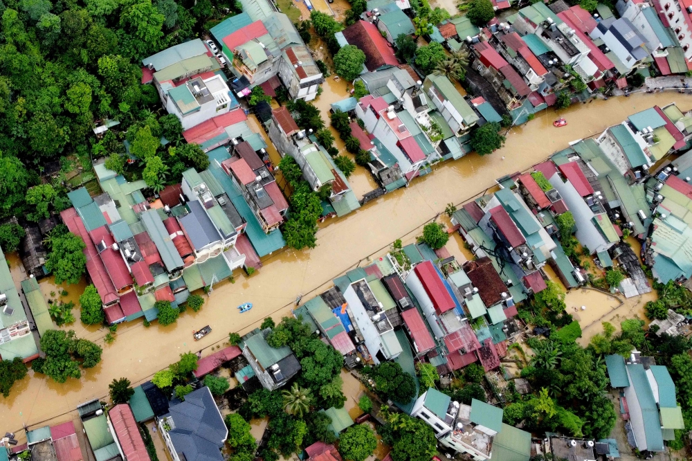 An aerial picture shows flood waters submerging buildings after heavy rain in Ha Giang city in northern Vietnam June 10, 2024. — AFP pic
