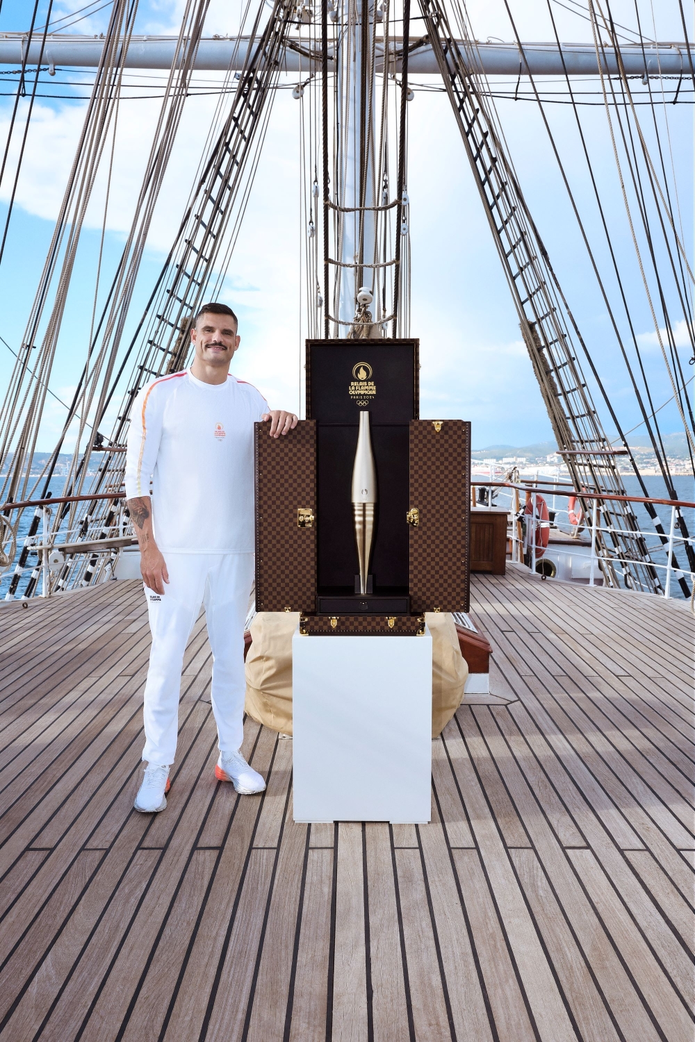 The trunk was opened by French swimmer Florent Manaudou, the first torchbearer to carry the flame in France. — Picture courtesy of Louis Vuitton