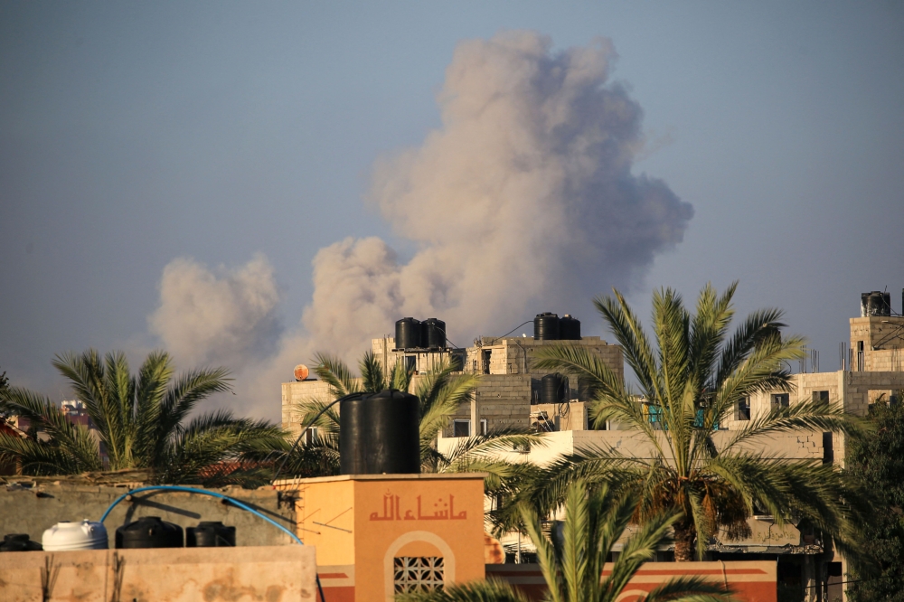 This picture taken from the central Gaza Strip town of al-Zawaida shows smoke billowing following an Israeli strike. — AFP pic