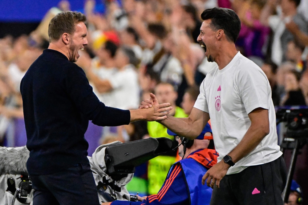 Germany’s head coach Julian Nagelsmann (left) and his assistant Sandro Wagner (right) celebrate during the Uefa Euro 2024 Group A football match between Germany and Scotland at the Munich Football Arena in Munich on June 14, 2024. — AFP pic