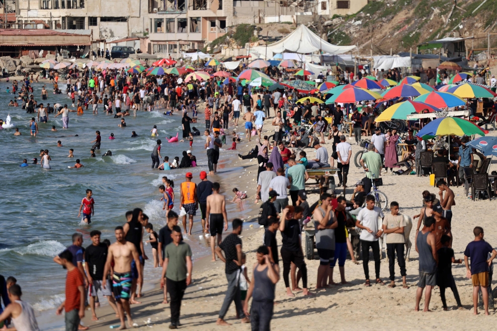 File photo of Palestinians gathering at the beach as temperatures soar in Gaza City on June 14, 2024, amid the ongoing conflict between Israel and the Palestinian Hamas militant group. — AFP pic