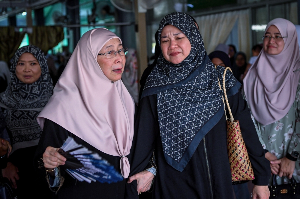 Datuk Seri Dr Wan Azizah Wan Ismail (left) extends condolences to Education Minister Fadhlina Sidek (right) while paying final respects Datin Siti Zalikhah Mohd Nor, at Surau Al-Mujahidin, Desa Surada, Kajang June 16, 2024. — Bernama pic