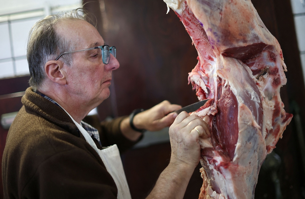 Butcher Gerardo Tomsin cuts meat in his shop, in Buenos Aires June 10, 2024. — Reuters pic  