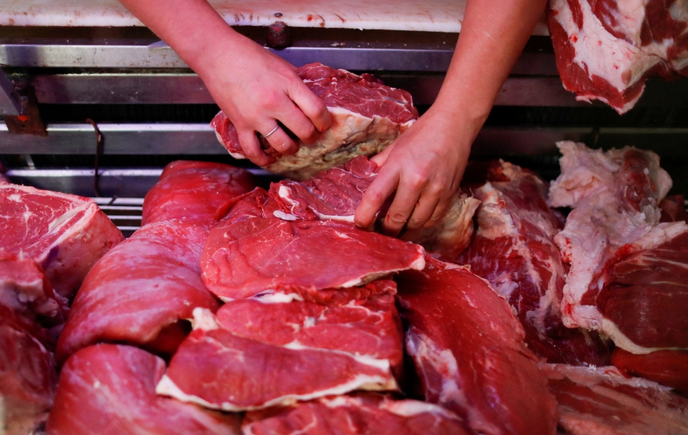 Butcher Pablo Alberto Monzon selects a piece of meat at his shop, in General Pacheco, on the outskirts of Buenos Aires May 19, 2021. — Reuters pic  