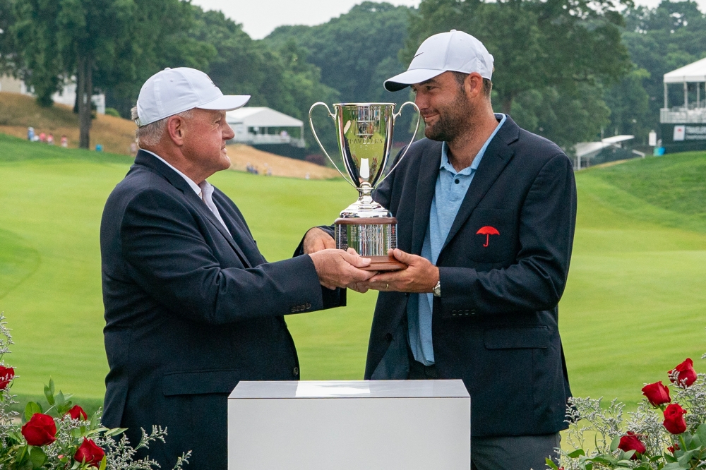 Scottie Scheffler is presented with the Travelers Championship Trophy after winning the Travelers Championship golf tournament at TPC River Highlands June 23, 2024. ― Gregory Fisher-USA TODAY Sports via Reuters