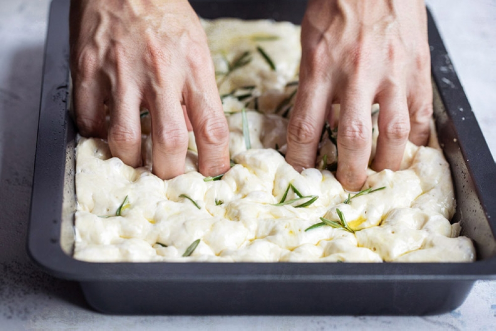 Press your fingers into the dough to make the focaccia’s signature ‘dimples’ or deep indentations.