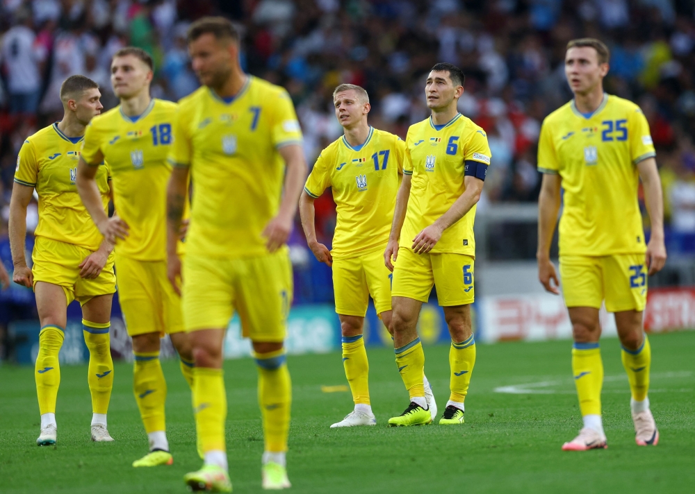 File photo of Ukraine’s Taras Stepanenko and Oleksandr Zinchenko looking dejected after their Euro 2024 qualifying match. — Reuters pic