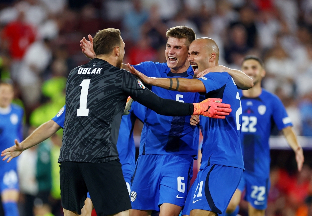 File photo of Slovenia’s Jaka Bijol, Jan Oblak and Vanja Drkusic celebrate after their Euro 2024 Group C match against England at the Cologne Stadium in Cologne, Germany, June 25, 2024. — Reuters pic