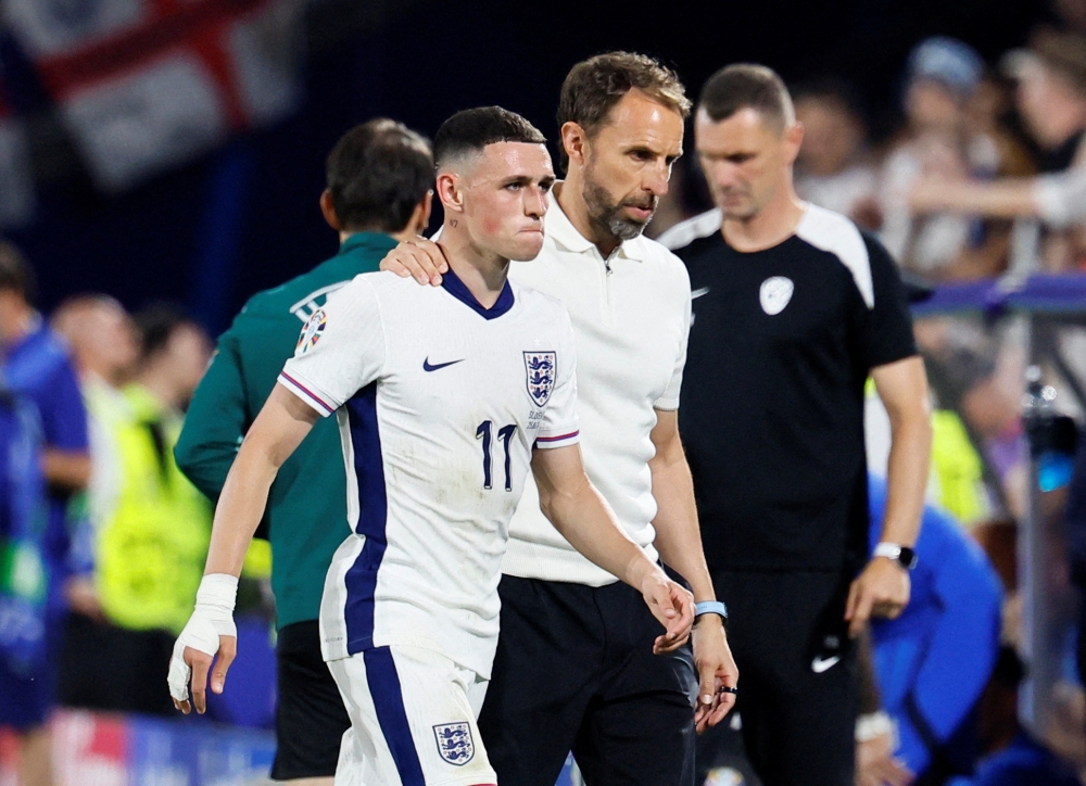 File phot of England’s Phil Foden with manager Gareth Southgate after being substituted during their Euro 2024 Group C match against Slovenia at the Cologne Stadium in Cologne, Germany, June 25, 2024. — Reuters pic