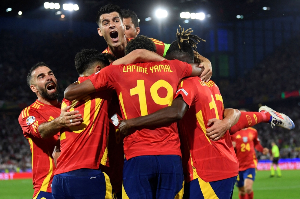Spain's Fabian Ruiz celebrates scoring their second goal with Alvaro Morata and teammates. — Reuters pic