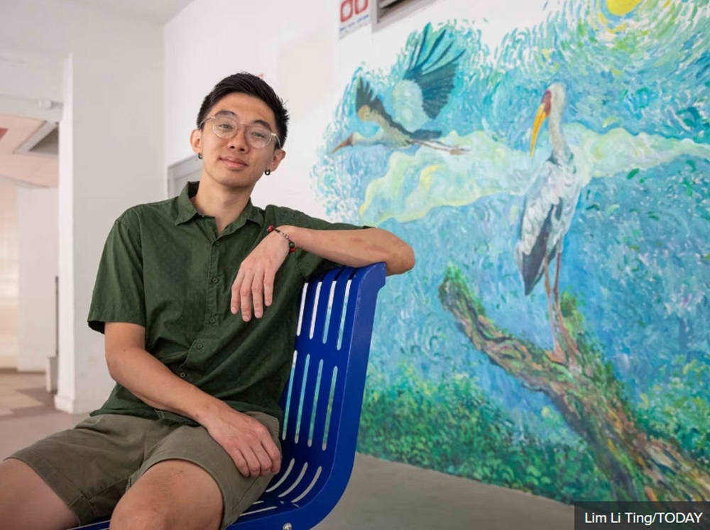 Artist Jacky Mak with one of his murals on display at the void deck of Block 223, Serangoon Avenue 4. — TODAY pic