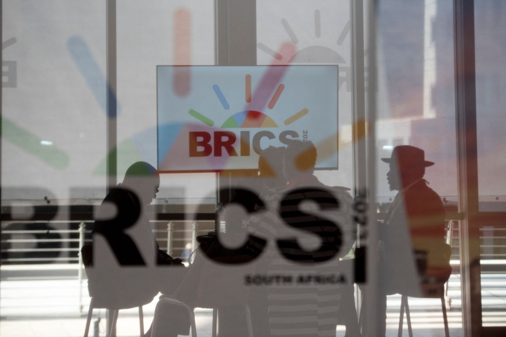 File picture of South African delegates sitting behind a glass with Brics logo as the Brics Summit is held in Johannesburg, August 23, 2023. Finding a way for Brics  to complement rather than compete with Asean’s initiatives will be crucial. This approach will ensure a more convergent educational landscape in South-east Asia, according to the author. —  Reuters pic 