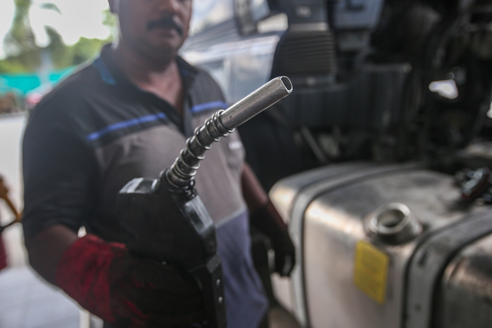 A vehicle owner refuels his lorry with diesel at a petrol station in Kanthan, Perak June 10, 2024. — Picture by Farhan Najib