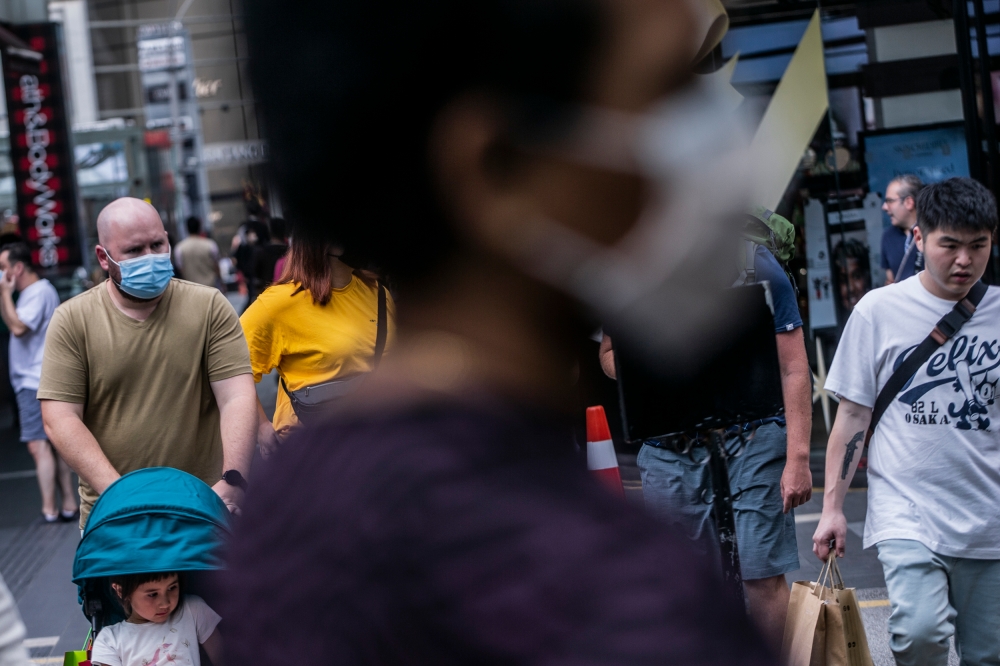 Under the new guidelines, the use of face masks remains mandatory for Covid-19 positive individuals and anyone experiencing respiratory symptoms. — Picture by Hari Anggara