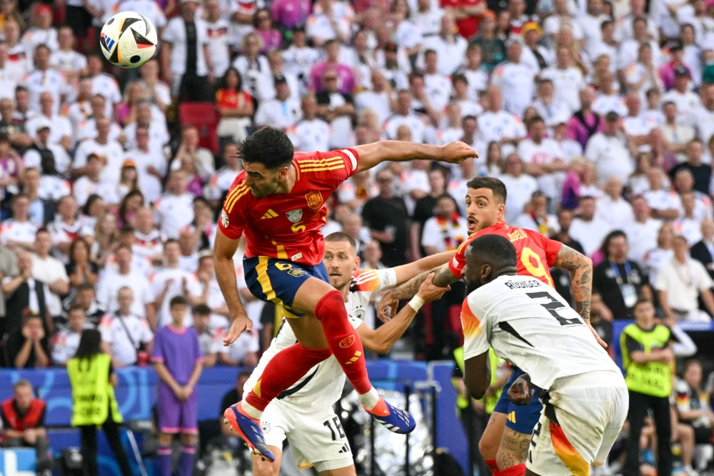 Spain’s midfielder #06 Mikel Merino heads the ball to score the second goal. — AFP pic