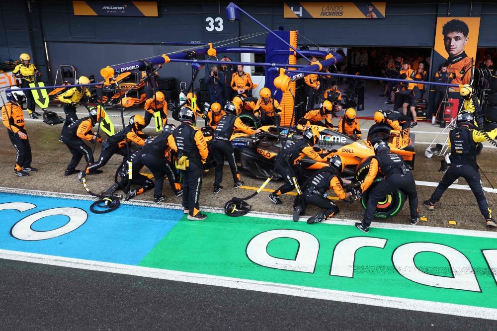 Mechanics change the tyres of McLaren's British driver Lando Norris during the Formula One British Grand Prix at the Silverstone motor racing circuit in central England, on July 7, 2024. — AFP pic