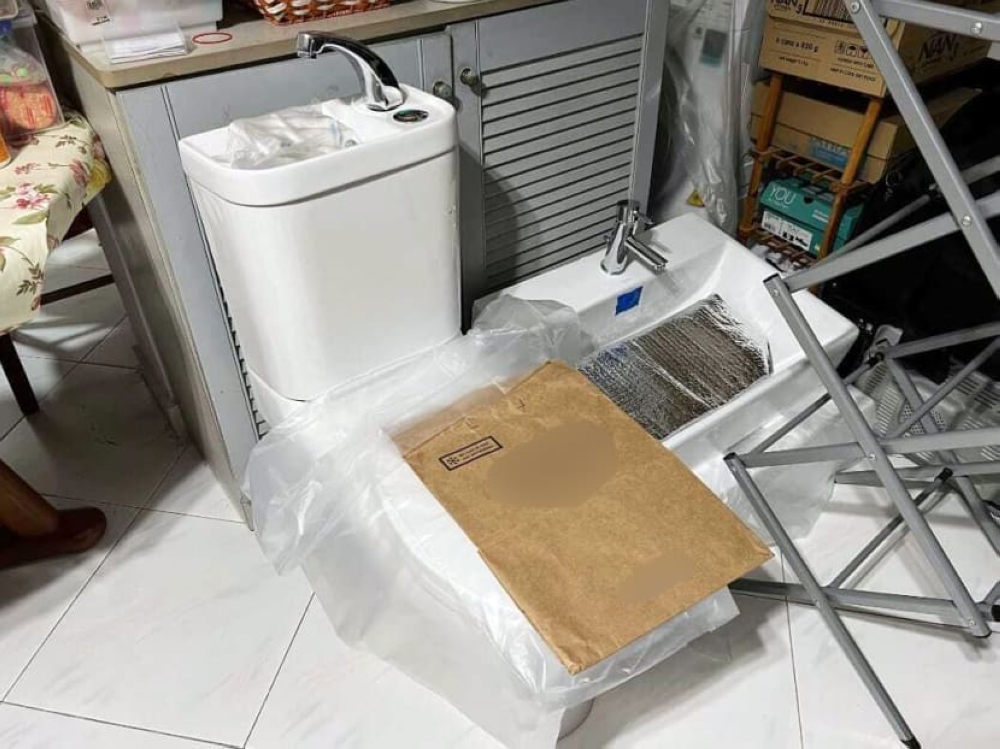 A discarded toilet bowl (left) and sink (right) from a Build-to-Order flat. The toilet bowl is designed to allow water used for handwashing at an attached basin to be directed to its water tank and used to flush the toilet. — Picture courtesy of Reno Guys