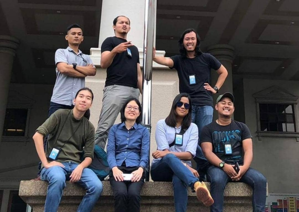 The writer (in olive) and his colleagues at the Kuala Lumpur Court Complex on the first day of Najib's prosecution in 2018.